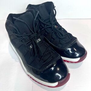 Kids Jordan 11’s Black and Red Sneakers